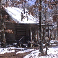 Snow on the log cabin.