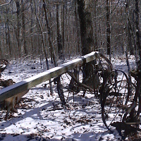 Horse drawn cultivator covered in snow.